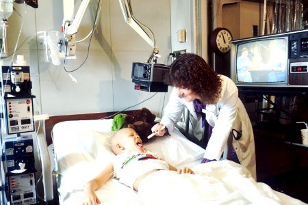 Doctor examines pediatric patient photo