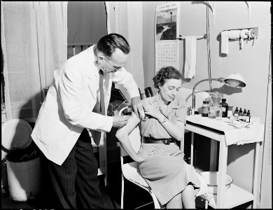 Doctor gives wife of miner an innoculation in dispensary. Inland Steel Company, Wheelwright ^1 & 2 Mines... - NARA - 541466