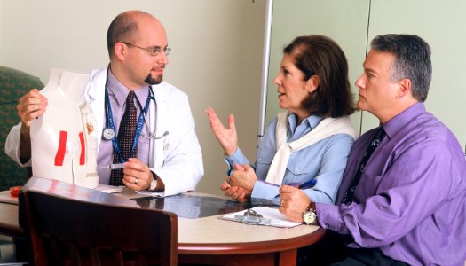 Doctor and couple talking photo