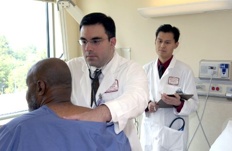 Doctor examines patient (1) photo
