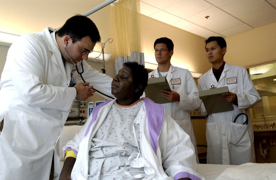 Doctor examines patient with stethoscope (1)