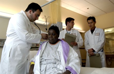 Doctor examines patient photo