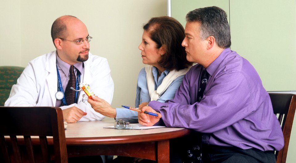 Doctor and couple talking (1) photo