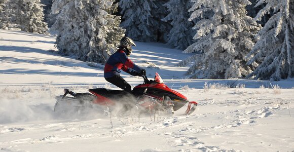 Action snowmobile mountains