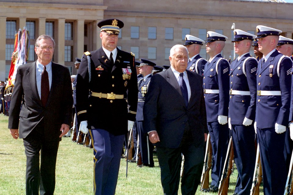 Donald Rumsfeld, Ariel Sharon, and Thomas Jordan inspects the troops at the River Parade Field