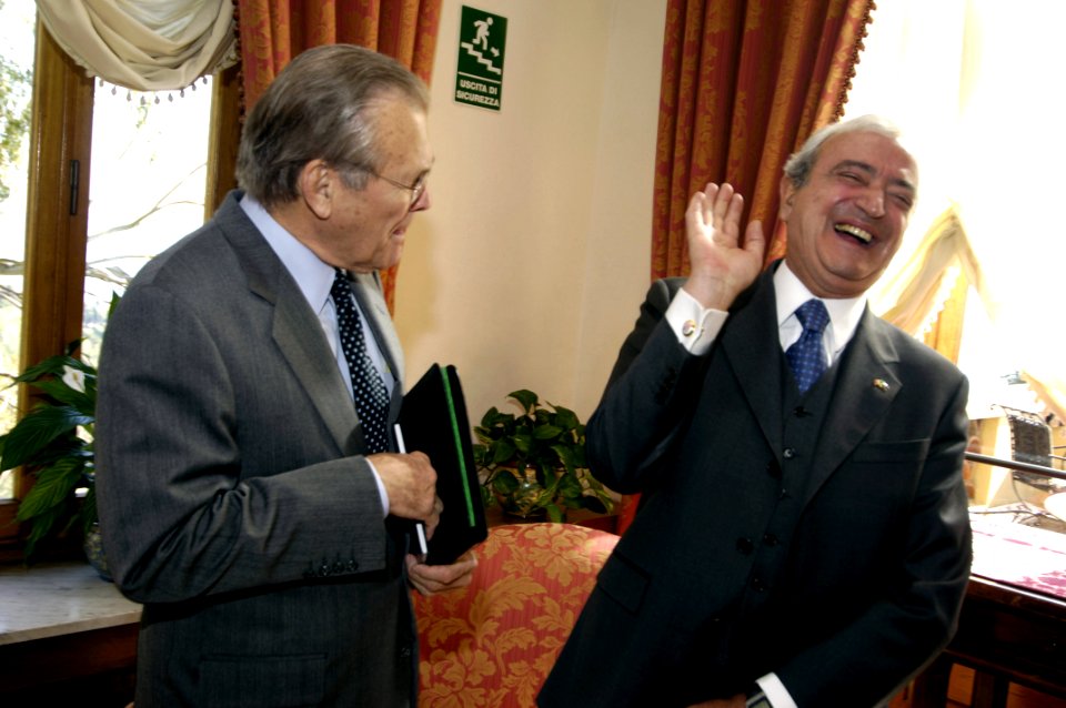 Donald Rumsfeld shares a laugh with Antonio Martino