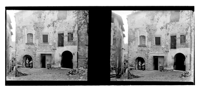 Dones i nena a l’entrada d’una casa de poble
