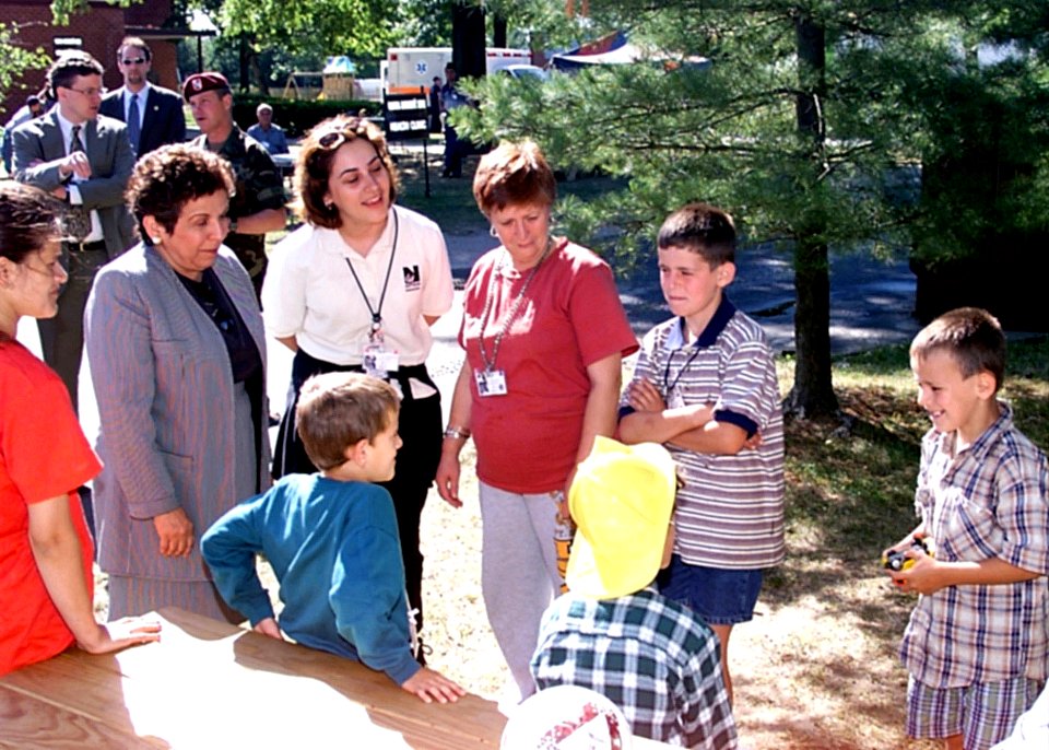 Donna Shalala visits with young Kosovo children at the playground