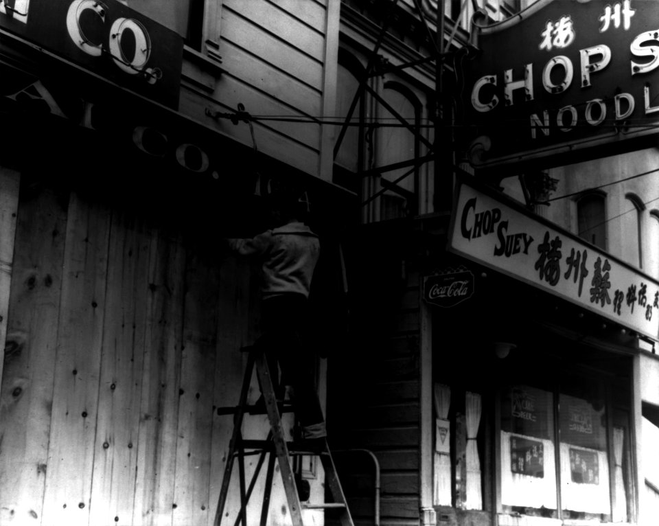 Dorothea Lange, Japanese-American boarding up store front before relocation, San Francisco, 1942