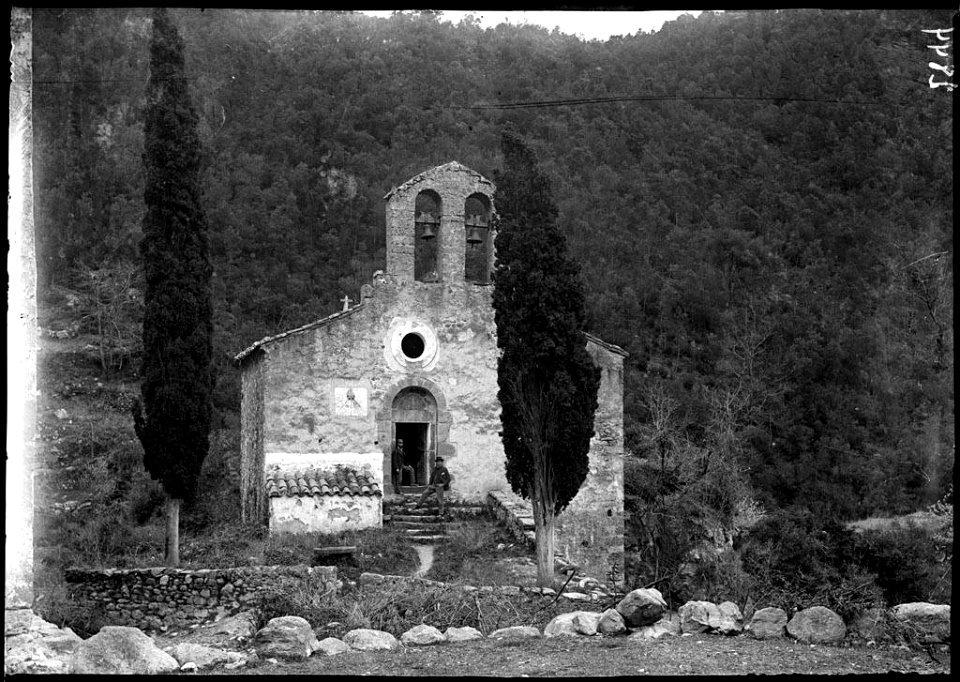 Dos homes davant l'església a Sant Aniol d'Aguja (AFCEC VINTRO D 2844)