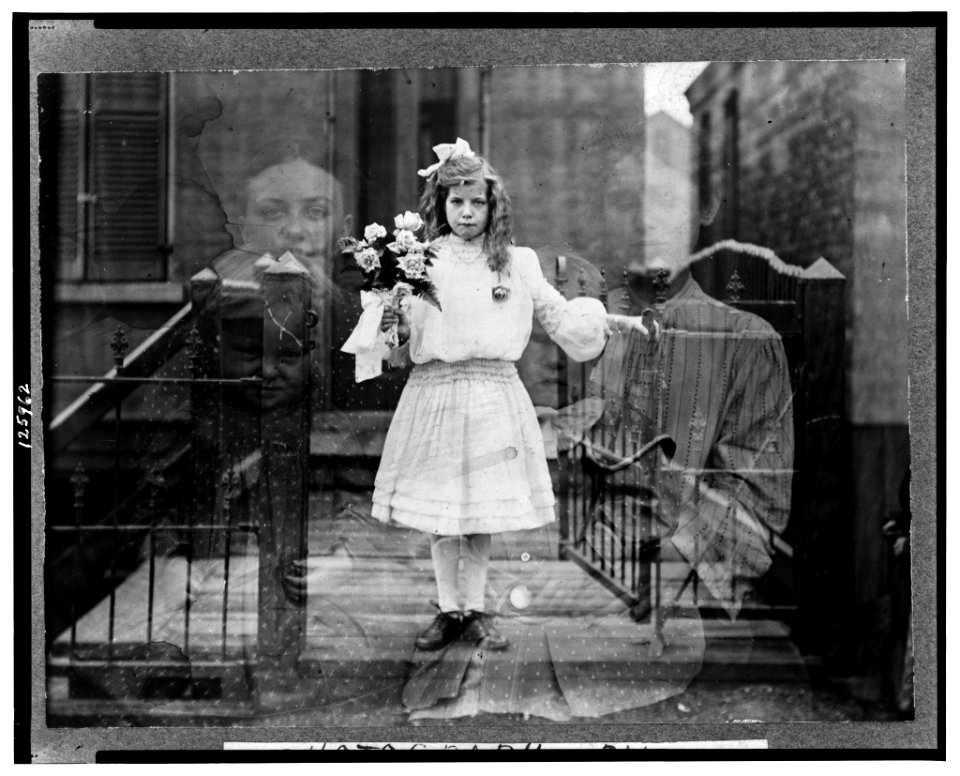 Double exposure spirit photograph of girl standing, holding flowers, surrounded by spectral figures of three people) - photograph by G.S. Smallwood, Chicago, Ill LCCN00650172