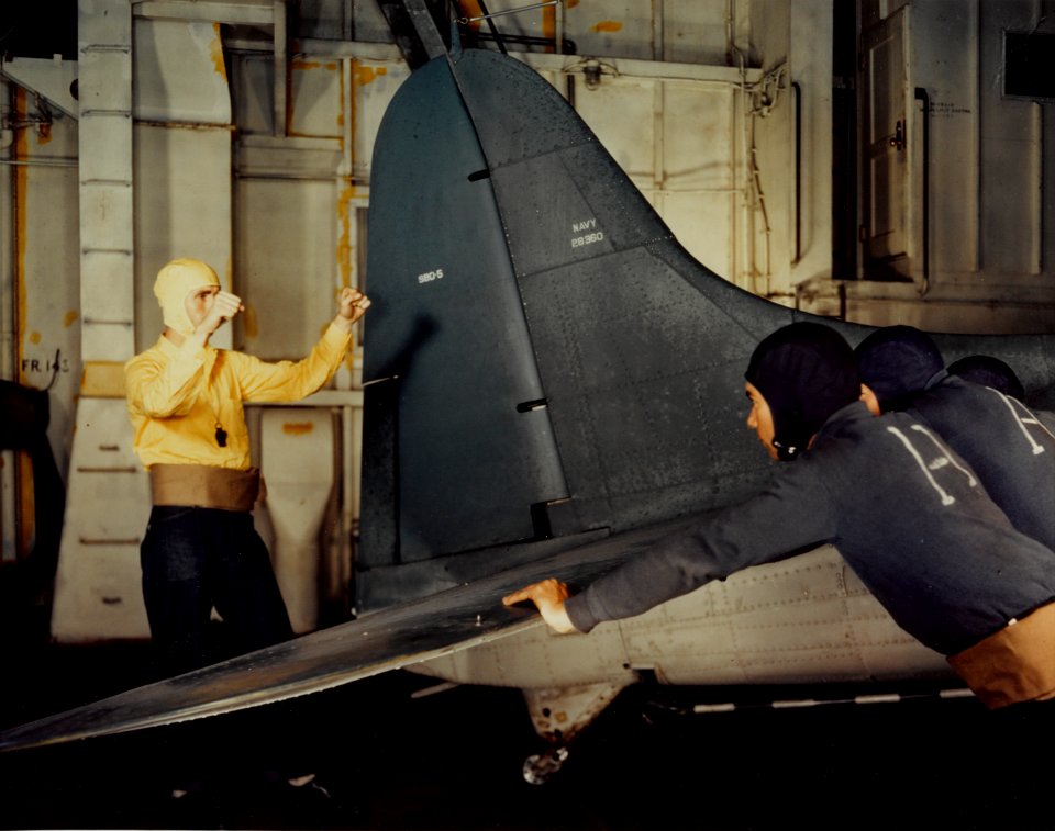 Douglas SBD-5 is pushed in hangar of escort carrier c1944