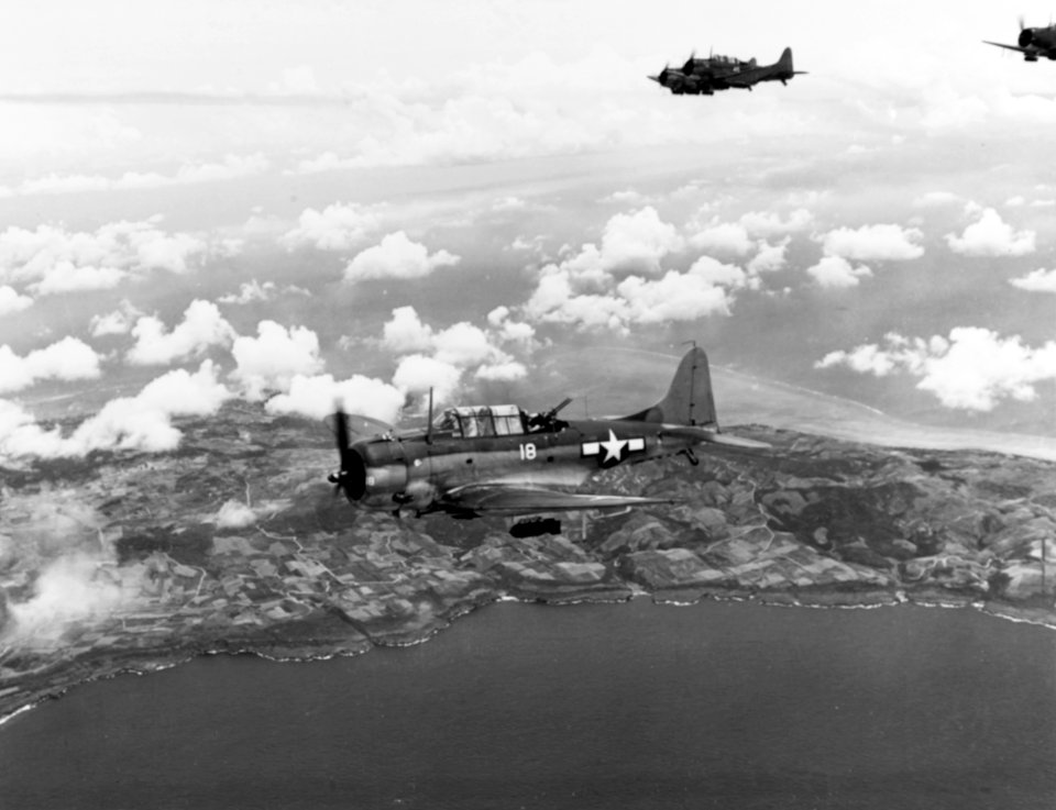 Douglas SBDs of Bombing Squadron 16 in flight over Saipan on 15 June 1944