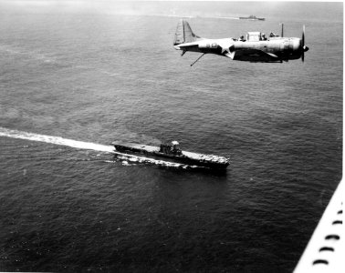 Douglas SBD flies over USS Enterprise (CV-6) and USS Saratoga (CV-3) on 19 December 1942 photo