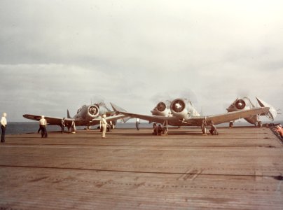 Douglas SBDs and Grumman TBFs on an escort carrier in 1943
