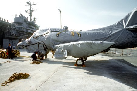 Douglas TA-4J Skyhawk is wrapped in protective covering prior to being loaded aboard USS Okinawa (LPH-3) at NAS Cubi Point, 4 June 1992 (6480685)