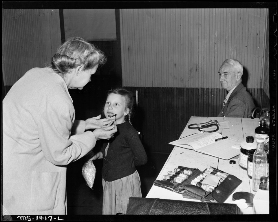 Dr. and Mrs. Rucker and patient, child of miner. Children in this camp had numerous sores and boils which Dr. and... - NARA - 540792