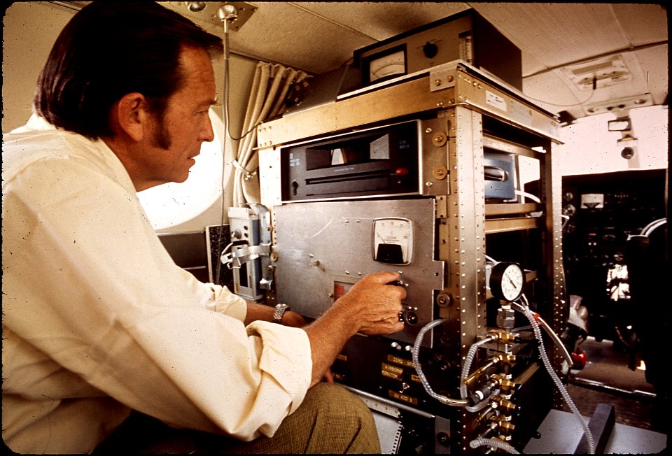 DR. JAMES N. PITTS, DIRECTOR OF AIR POLLUTION RESEARCH CENTER WITH MONITORING EQUIPMENT INSIDE NASA - NARA - 542668