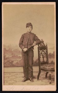 Drummer Robert Henry Hendershot (Drummer Boy of the Rappahannock) of Co. B, 8th Michigan Infantry Regiment in uniform with drum sticks in front of painted backdrop) - Kertson & Barker, 142 LCCN2017659639