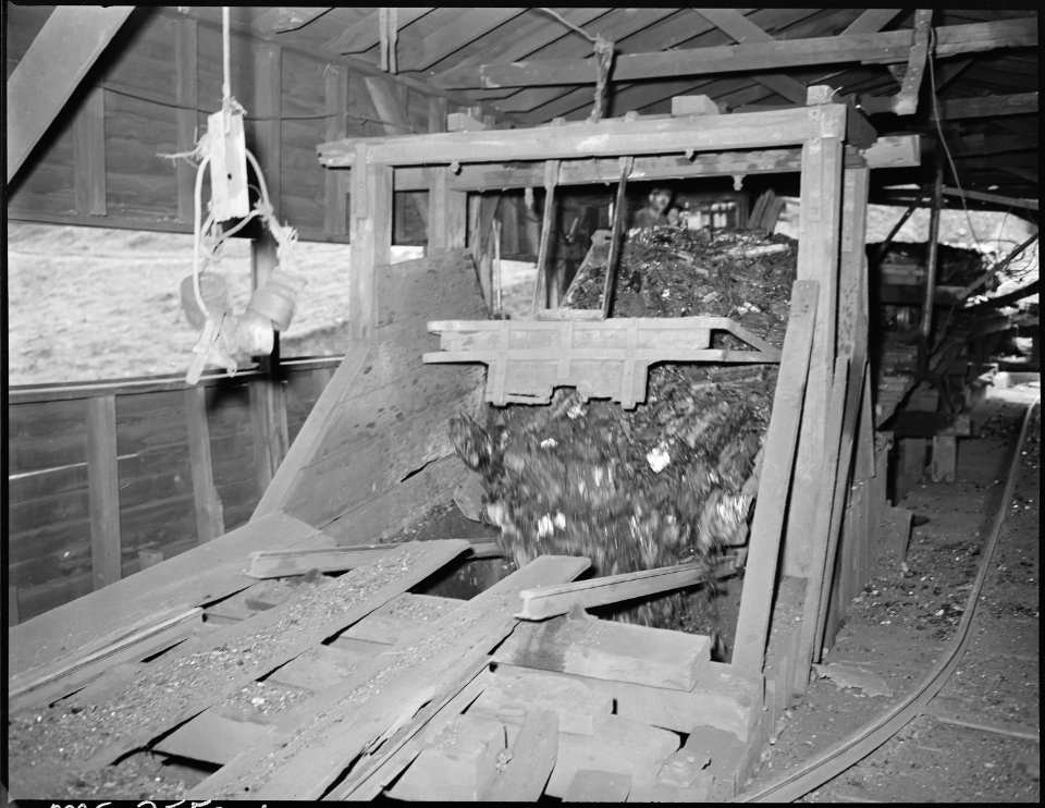 Dumping a car of coal at the tipple. P V & K Coal Company, Clover Gap Mine, Lejunior, Harlan County, Kentucky. - NARA - 541305
