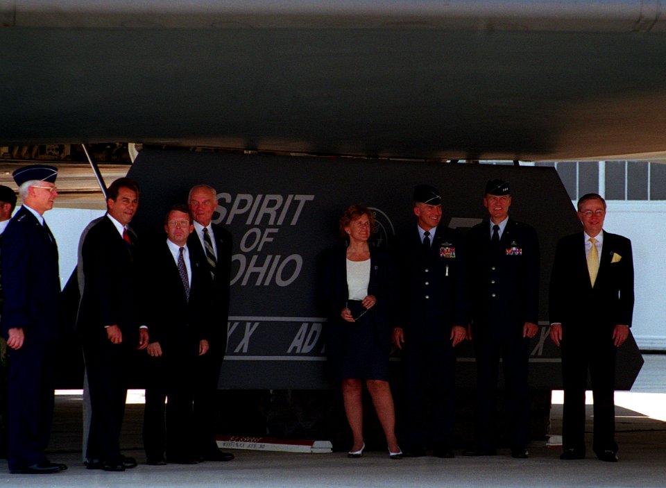 During dedication of the B-2 Spirit of Ohio stealth bomber, dignitaries pose in front of the aircraft's landing gear cover