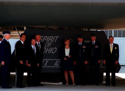 During dedication of the B-2 Spirit of Ohio stealth bomber, dignitaries pose in front of the aircraft's landing gear cover
