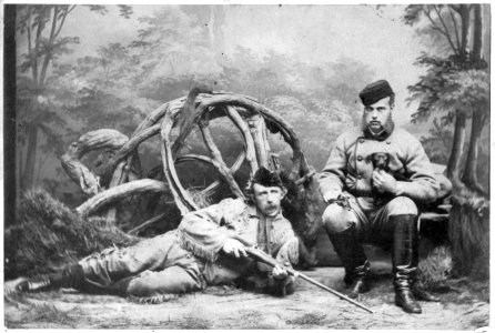 George Armstrong Custer, reclining in buckskin hunting outfit with rifle, Grand Duke Alexis seated beside him holding puppy LCCN2016646390