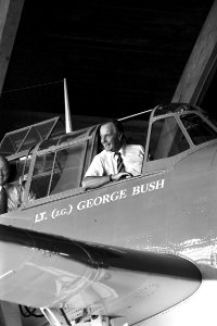 George H. W. Bush sits in the cockpit of a U.S. Navy TBM-1C Avenger aircraft in Fargo
