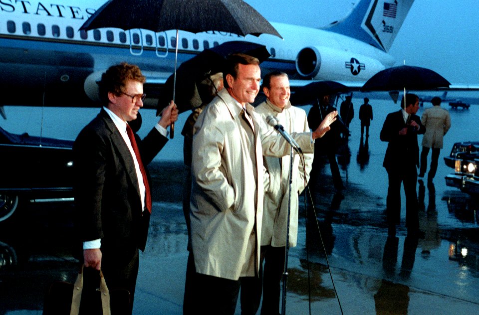 George H. W. Bush greets a crowd upon his arrival