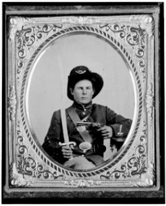 George Kimbrue, Pvt., 93rd Indiana Infantry, U.S.A., half-length portrait, seated holding a pistol and a saber LCCN2005695745