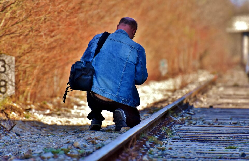 Camera bag kneeling photographer