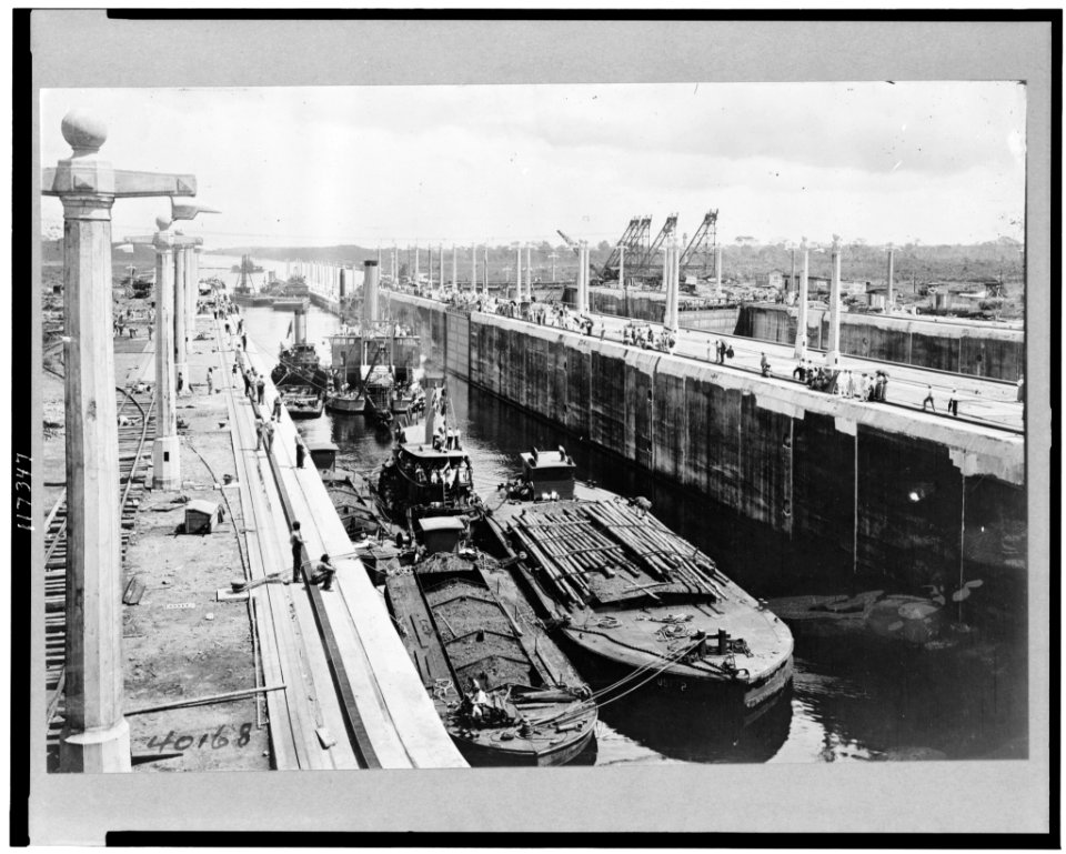 Gatun locks looking toward Atlantic entrance of canal, showing tugs, dredges, and barges ready for first lockage from sea level up into Lake Gatun ... LCCN96522036