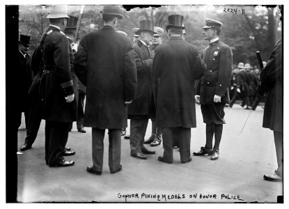 Gaynor pinning medals on honor police LCCN2014688110