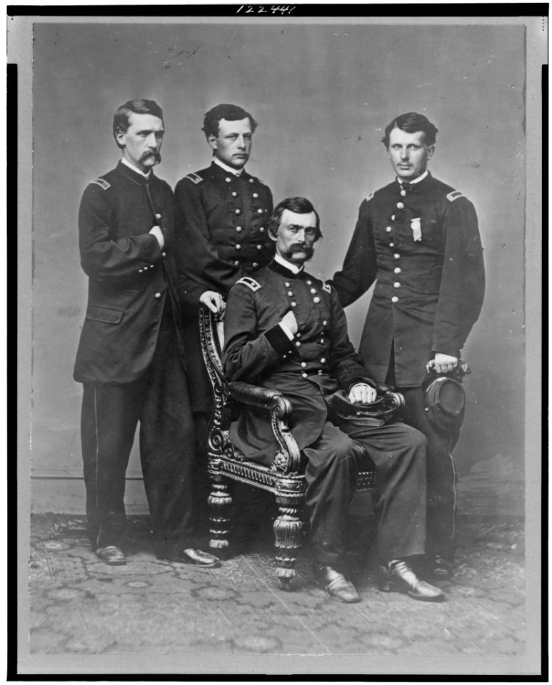 General Charles Griffin, full-length portrait, seated, with three aides standing behind him LCCN99401114