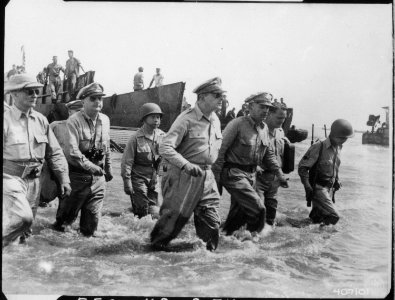 General Douglas MacArthur wades ashore during initial landings at Leyte, Philippine Islands - NARA - 531424