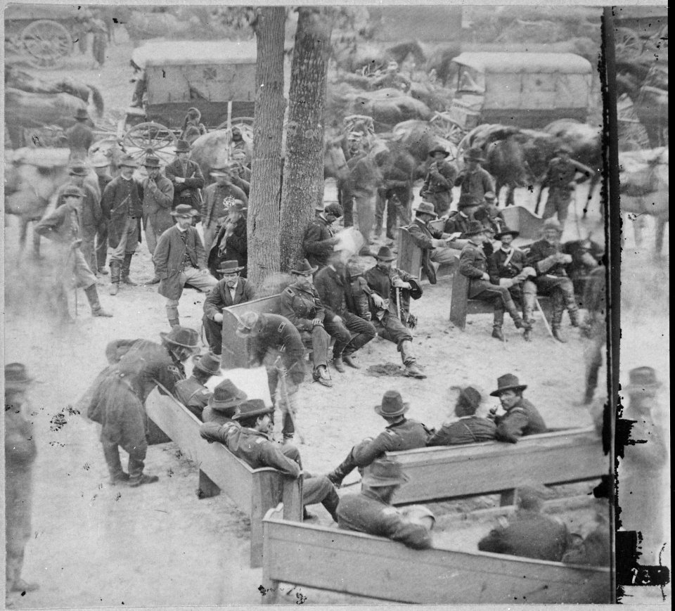 General Grant's Council of War near Massaponax Church, Virginia. Grant is bending over the bench looking over General Me - NARA - 559272