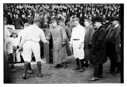 General Leonard Wood shakes hands with a Yankee baseball player as Yankees Manager Bill Donovan stands to the right of him, Polo Grounds, New York (baseball) LCCN2014704383