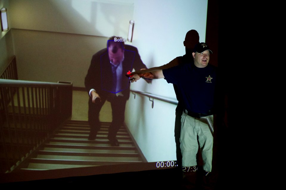 Guy points out target to law enforcement explorers
