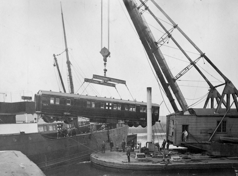 GWR railway carriage, marked with a Red Cross, being loaded onto the SS Africa