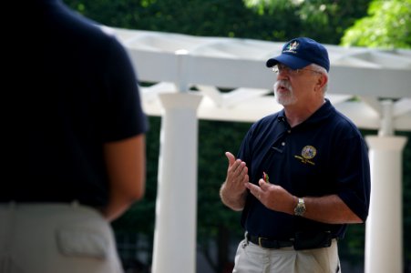 Guy with hat talks to law enforcement explorers photo