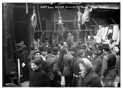East side crowd discussing price of meat in front of shops, New York LCCN2014684605