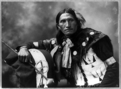 Eddie Plenty Holes, a Sioux Indian, half-length portrait, facing front, holding tomahawk LCCN92509997