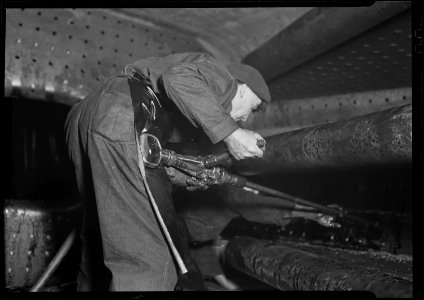 Eddystone, Pennsylvania - Railroad parts. Baldwin Locomotive Works. Boilermaker tapping for stay-bolts in boiler of a... - NARA - 518714