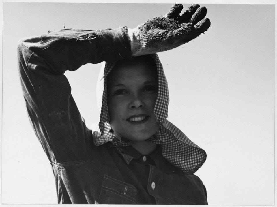 Edison, Kern County, California. Young girl looks up from her work. She picks and sacks potatoes on . . . - NARA - 521812