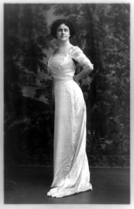 Edith Bolling Galt Wilson, full-length portrait, standing, facing front, hands behind waist LCCN93516290