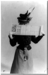 Edna Wallace Hopper, three-quarter length portrait, standing, facing right, looking over schedule for Chicago & Alton Railroad LCCN91481439