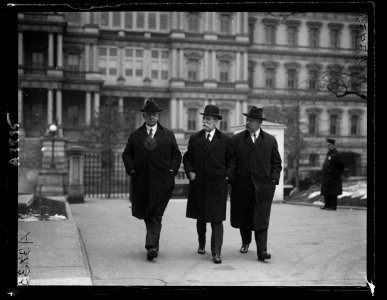 Edwin Denby, Charles Evans Hughes, and John W. Weeks. State, War and Navy Building in background, Washington, D.C. LCCN2016891136