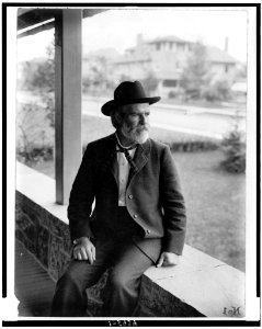 Edwin Markham, three-quarter length portrait, seated, facing left LCCN92514221