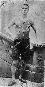 Ehrich Weiss, full-length portrait, standing, facing front, wearing track team medals, in New York LCCN96519230