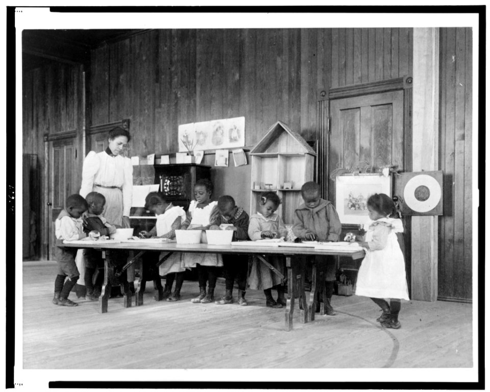 Eight African American children, in kindergarten, learning washing and ironing at Whittier Primary School, Hampton, Virginia LCCN98514248